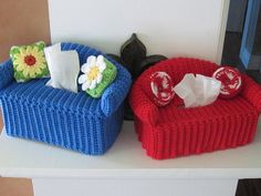 two knitted couches sitting on top of a white table next to each other