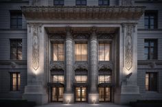 an old building with columns lit up at night