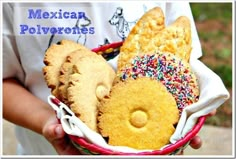 a person holding a basket filled with different types of mexican pastries in it's hands