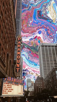 the marquee for paramount is painted with multi - colored fluid paint on it