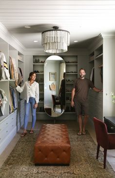 a man and woman are standing in the closet