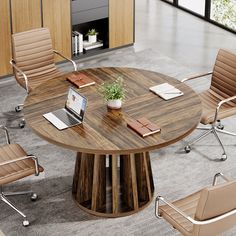 a round table with four chairs around it and a laptop on the desk in front of it