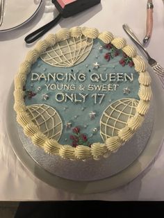 a cake sitting on top of a table next to utensils and other items