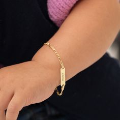 A classic engravable tag id bracelet for baby girls and boys that features an elegant figaro chain. This bracelet is crafted from genuine 14k yellow gold, a material that is safe for your baby with sensitive skin. This classic bracelet makes for a beautiful gift for a baby or toddlers special birthday. Gift box included with purchase. Age Group: Lovely Gifts For Babies and Toddlers Material: 14k Yellow Gold Bracelet Length: 5.5 inches (13.9 cm) Tag Size: 18mm W x 5mm H Metal Stamp: 14k Gift Box Baby Bracelet For Boys, Baby Boy Jewelry Gold Bracelets, Toddler Gold Bracelet, Baby Girl Bracelets Gold, Baby Boy Bracelet Gold Kids, Gold Chain Design, Classic Bracelets, Kids Bracelets, Id Bracelets