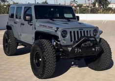 a gray jeep parked in a parking lot