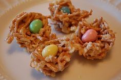 some kind of food on a plate with candy eggs and cereal balls in the middle