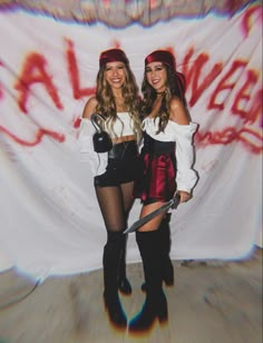 two young women dressed in costumes posing for a photo with one holding a knife and the other wearing thigh high boots