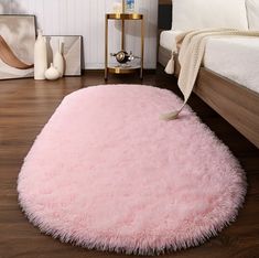 a pink rug on the floor in a bedroom