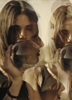 two women are blowing bubbles in front of their faces