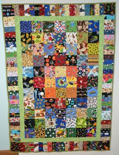 a very colorful quilt hanging on the wall