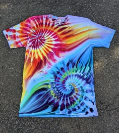 a colorful tie - dyed t - shirt laying on the ground