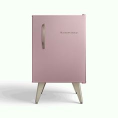 a pink refrigerator sitting on top of a wooden stand