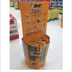 an orange display case filled with lots of different colored candy bar wrappers in a store