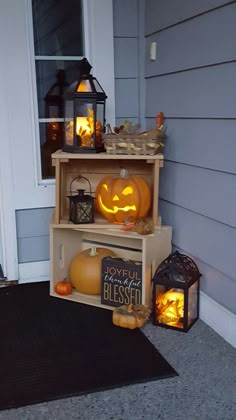 two shelves with pumpkins and lanterns on them