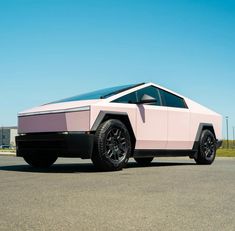 a pink and black car is parked on the street