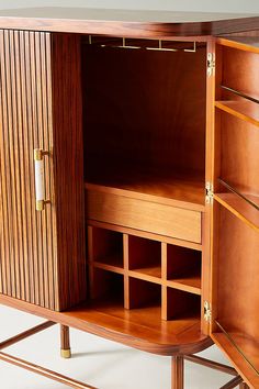 a wooden cabinet with several compartments and shelves