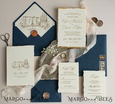 the wedding stationery is laid out on top of an envelope and some other items