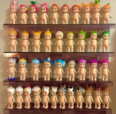 there are many toy dolls on the shelves