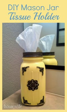 a yellow mason jar with tissue paper in it and the words diy mason jar tissue holder