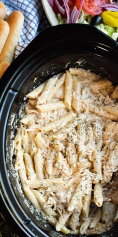 the pasta is being cooked in the crock pot and ready to be served on the table