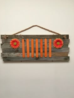 a wooden sign with orange flowers on it