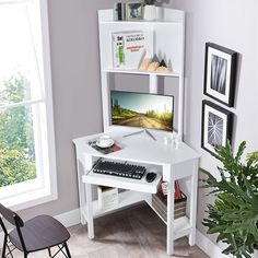 a white computer desk with a keyboard and monitor