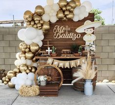 a table topped with balloons and other items in front of a sign that says mr & mrs babatgo