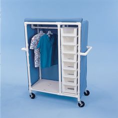 a blue and white cart with clothes hanging on it's sides, in front of a light blue background