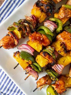 chicken and vegetable kabobs on a white plate