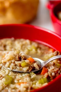 a red bowl filled with rice and vegetables