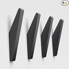 three black metal brackets on a white wall with the words,'3 different sizes and shapes