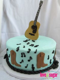 a birthday cake with a guitar on top