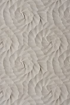 an abstractly designed wall in white marble