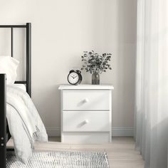 a bedroom with a bed, nightstand and clock on the side table next to it