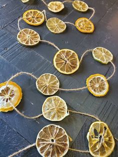 orange slices are tied up to string on the floor