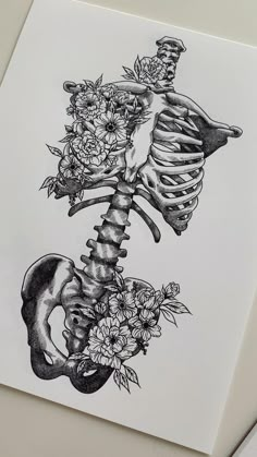 a drawing of a skeleton with flowers on it