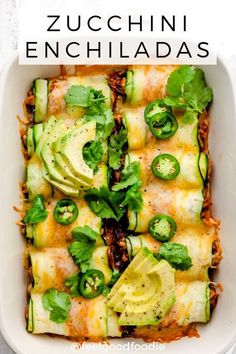 a casserole dish with zucchini enchiladas and green peppers