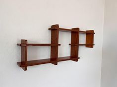 two wooden shelves mounted to the side of a wall