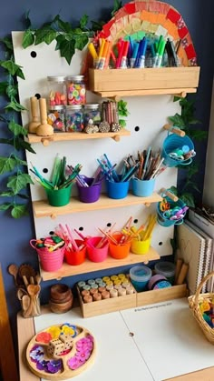 there are many craft supplies on the shelves in this child's playroom area