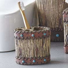 two toothbrush holders made out of tree trunks