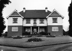 an old black and white photo of a large house