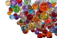 a cluster of multicolored glass balls hanging from a ceiling