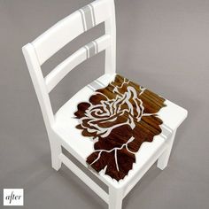 a white chair with a wooden seat and flower design on the backrest, against a gray background