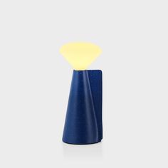 a small blue vase with a yellow light on it's top and the base