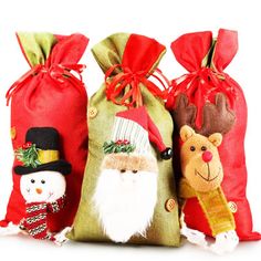 three christmas bags with santa claus, snowman and reindeer decorations on the front side