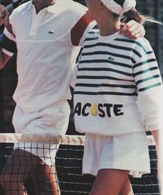 two tennis players hugging each other on the court