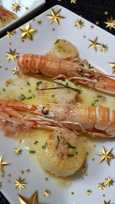 some food is on a white plate with gold stars around it and garnished with parsley