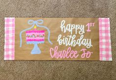 a happy 1st birthday banner with a cake on it