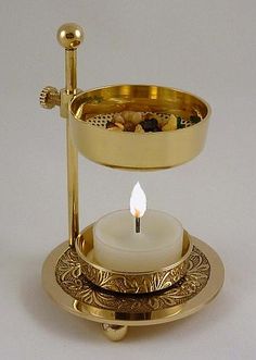 a candle that is on top of a stand with some kind of thing in it