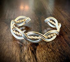 "PLEASE BE SURE TO LET ME KNOW IN A MESSAGE IF YOU PREFER A 6\", 7\", or 8\"+ SIZE CUFF. This fabulous  cuff style bracelet is the perfect accessory to compliment any outfit!  It goes with the Rowan Style Circlet too. Features twist and woven design inspired by Celtic knot work.  Simple, but definitely a statement!  Dress it up or wear it with your favorite T-shirt and a pair of jeans. It is crafted from thick anodized aluminum wire. It is entirely hypoallergenic and all nickel-free. It won't tarnish or turn your skin green either!  Even though it has that nice chunky look, it is light-weight and very comfortable.  Adjustable for a perfect fit every time.  it does help to get a wrist measurement if possible if your wrist is extra small or large. please message me.  Band measures about 3/4\ Celtic Wire Jewelry, Wire Bracelet Tutorial, Celtic Bracelet, Wire Jewelry Rings, Wire Wrap Jewelry Designs, Wire Wrapped Jewelry Diy, Brass Cuff Bracelet, Bijoux Fil Aluminium, Wire Jewelry Designs